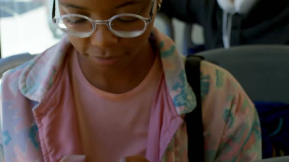 Female commuter using mobile phone while travelling in bus 4k