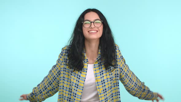 Beautiful and Carefree Woman in Glasses Having Fun Looking Happy Touching Hair and Laughing Joyfully