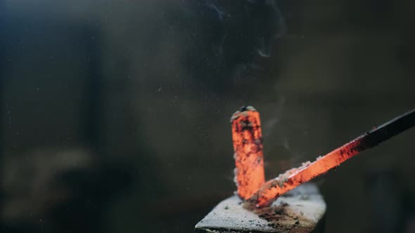 Handmade Blacksmithing in a Workshop. Blacksmith Forging Red-hot Blade of Knife in Smithy. The