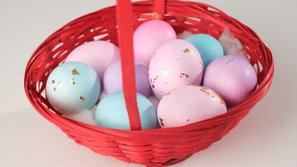 Painted Easter Eggs in a Basket Spinning on a White Background