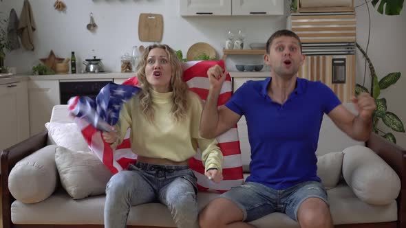 Family Couple of Soccer Fans at Home with USA Flag