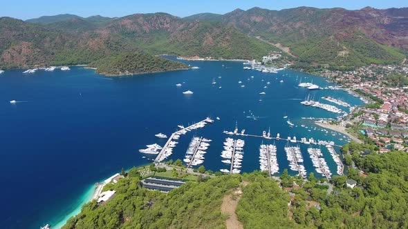 Small City Houses, Beautiful Marina and Touristic Boats in a Cove Surrounded by Forest by Sea