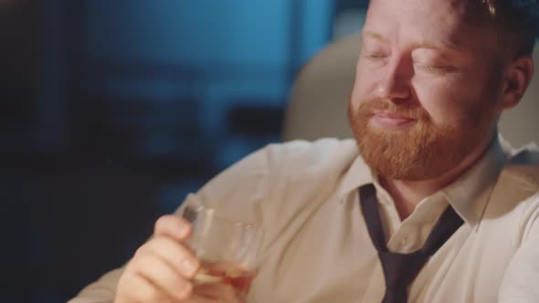 Stressed Businessman Drinking Alcohol at Workplace