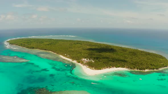 Tropical Daco Island with a Sandy Beach and Tourists.