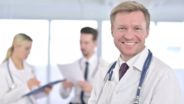 Portrait of Attractive Male Doctor Smiling at the Camera