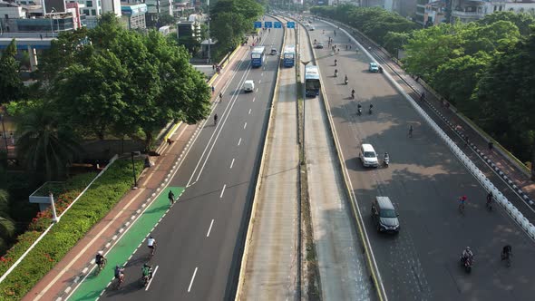 Aerial view of Bicyclist group riding on bike ride at highway, motorcycle and car