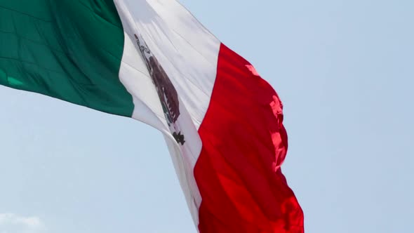 a big mexican flag moving slowly because of the air