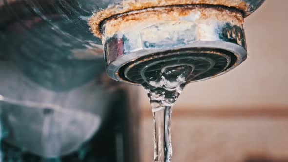 Faucet with Running Water in Slow Motion Macro Shot