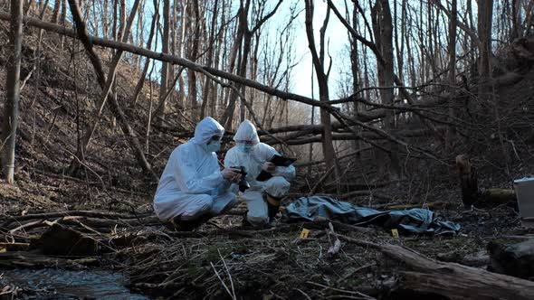 Forensic specialists working in the forest. Crime scene and police concept.