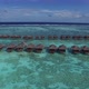 Aerial view of Maldives and luxurious over water villas. Luxury travel agency concept - VideoHive Item for Sale