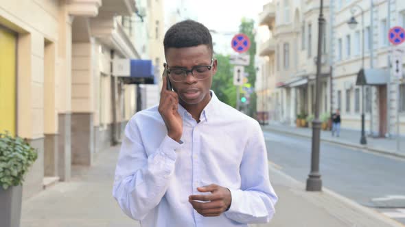 Walking African Man Talking on Phone