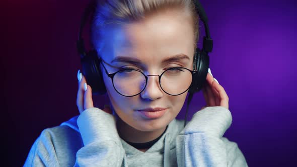 Portrait Attractive Girl in Glasses Wearing Earphones Listen Music and Dance