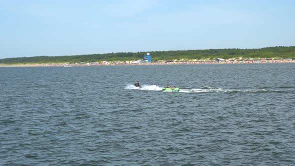 Tourists are Towed in a Water Tube