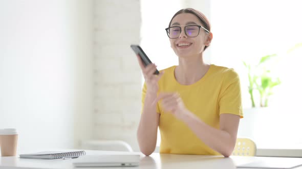 Woman Talking on Phone in Office