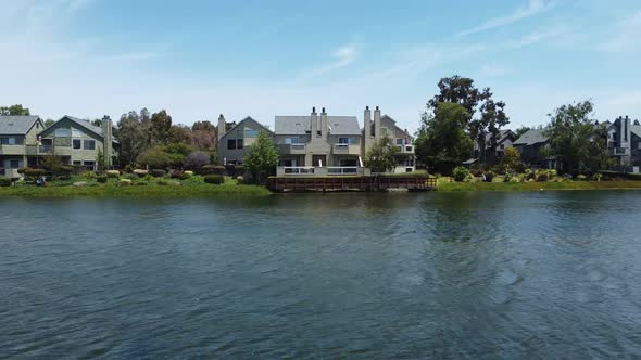 Drone Rising Up From Blue Lagoon Towards San Mateo Parkside Aquatic Park , Beautiful Villas, Califor