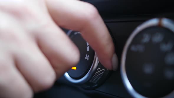Woman's Fingers Tuning Knob of Car Air Conditioner