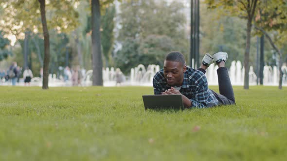 Successful Freelancer Business Man Teacher Student African American Guy Lying on Green Grass Lawn