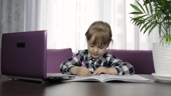 Girl Doing Online Homework Using Digital Laptop Computer. Distance Education