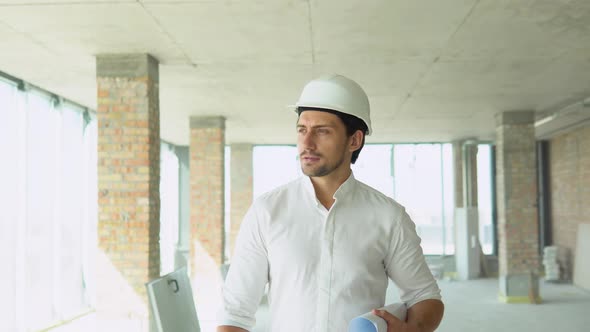 Engineer Developer in Helmet Inspecting Building alt