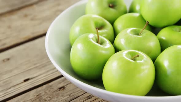 Green apples arranged in bowl