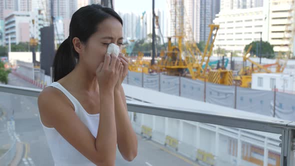 Woman suffer from air pollution of construction site 