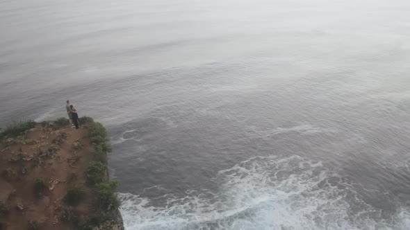 Aerial View of Beautiful Cliff and Ocean with People Walking