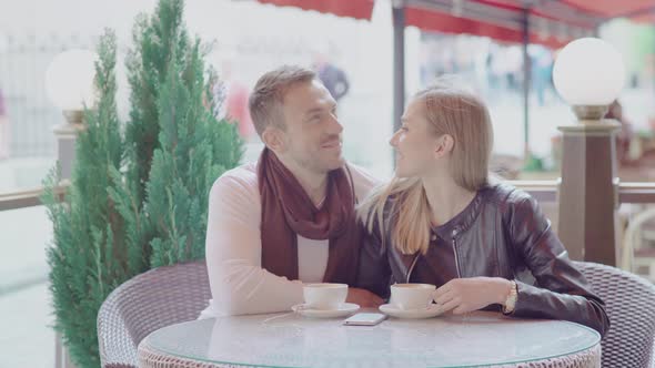 Romantic Couple Drinking Coffee On Date At Street Cafe