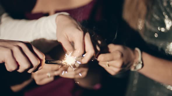 Asian Girl and Group Young College Student Friends Lit Light Sparkler in Hand Fireworks Sing and