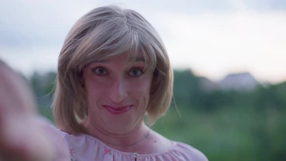 Selfie Camera POV of Cheerful Transgender Woman Talking and Smiling on Summer Meadow Outdoors