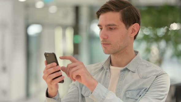 Portrait of Creative Young Man Using Smartphone