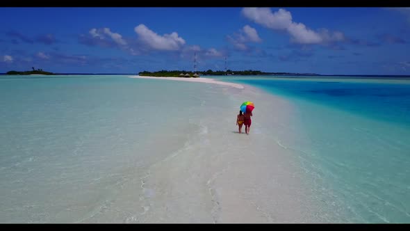 Man and woman engaged on tranquil resort beach journey by blue lagoon and clean sand background of t