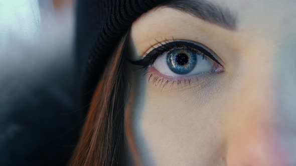 Closeup of Female Eye Opening with Beautiful Blue Iris