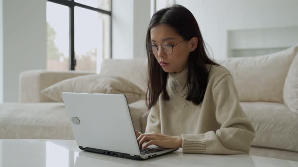 An Intense Asian Business Woman Working with Glasses Feeling Pain in Her Eyes Overexertion or