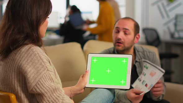 Business People Analysing Financial Statistics Holding Tablet with Green Screen