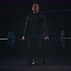 Man is Standing in Sport Gym Lifting a Heavy Barbell Over Himself in Arms - VideoHive Item for Sale