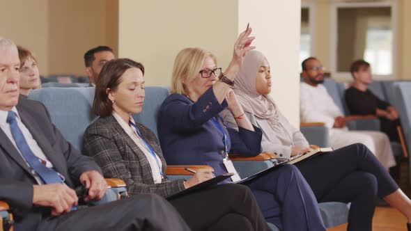 Businesswoman Asking Question at Conference