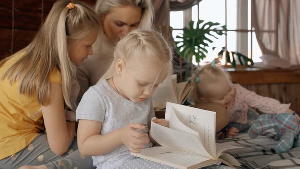 Mother with Kids Reading Book in Modern Interior Room