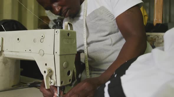 African man preparing the thread for sewing