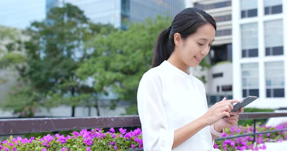 Woman use of mobile phone in city