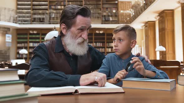 Bearded Man which Explaining to His Teen Grandson the Importance of Reading Books