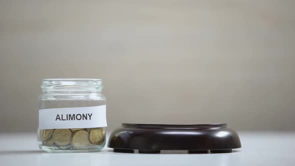 Alimony Glass Jar With Coins on Table, Gavel Striking on Sound Block, Government