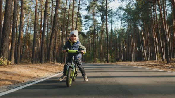 A Little Boy Rides on the Balance Bike, Close Up