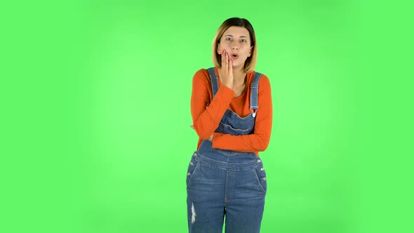 Girl Listens To Information Looking at Camera, Is Shocked and Very Upset . Green Screen