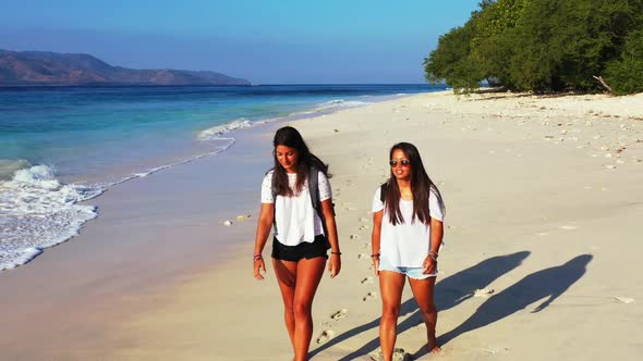 Girls look beautiful on marine coast beach journey by shallow water and white sand background of Gil