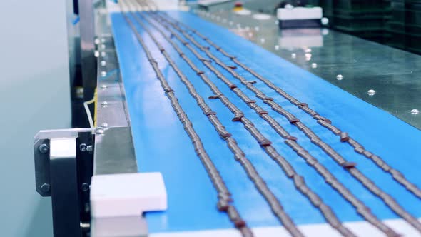 Confectionery Conveyor with Caramel Candies on It