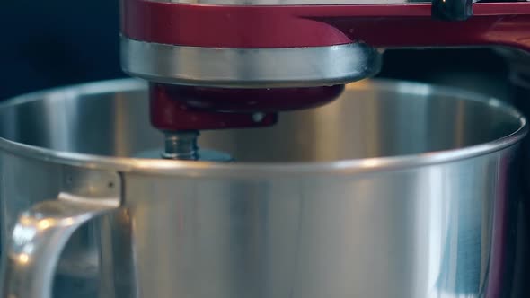 Mixer Automatically Spins in Metal Bowl Preparing Cream