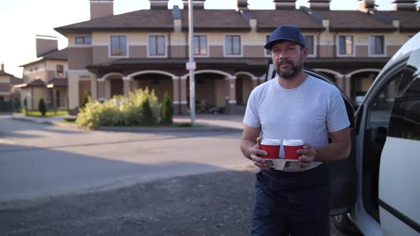 Worker of Food Delivery Service Delivering Coffee