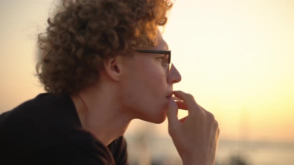 Caucasian Male Smoking Cigarette Alone Watching Evening Sun