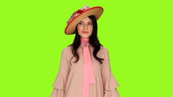 Graceful Young Brunette Woman in Beautiful Straw Hat Decorated with Flowers