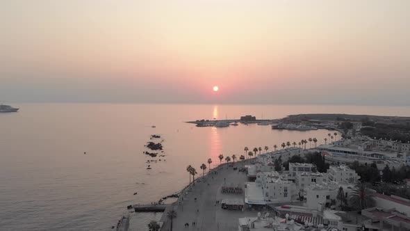 Beautiful Sunset on sea boulevard at Paphos, Cyprus - Aerial drone View 4K